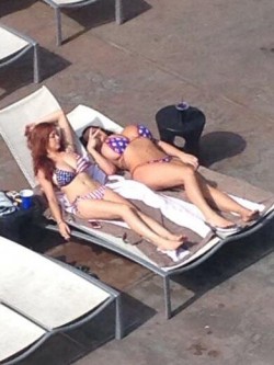 Leanne Crow & Tessa Fowler tanning while wearing American flag bikinis
